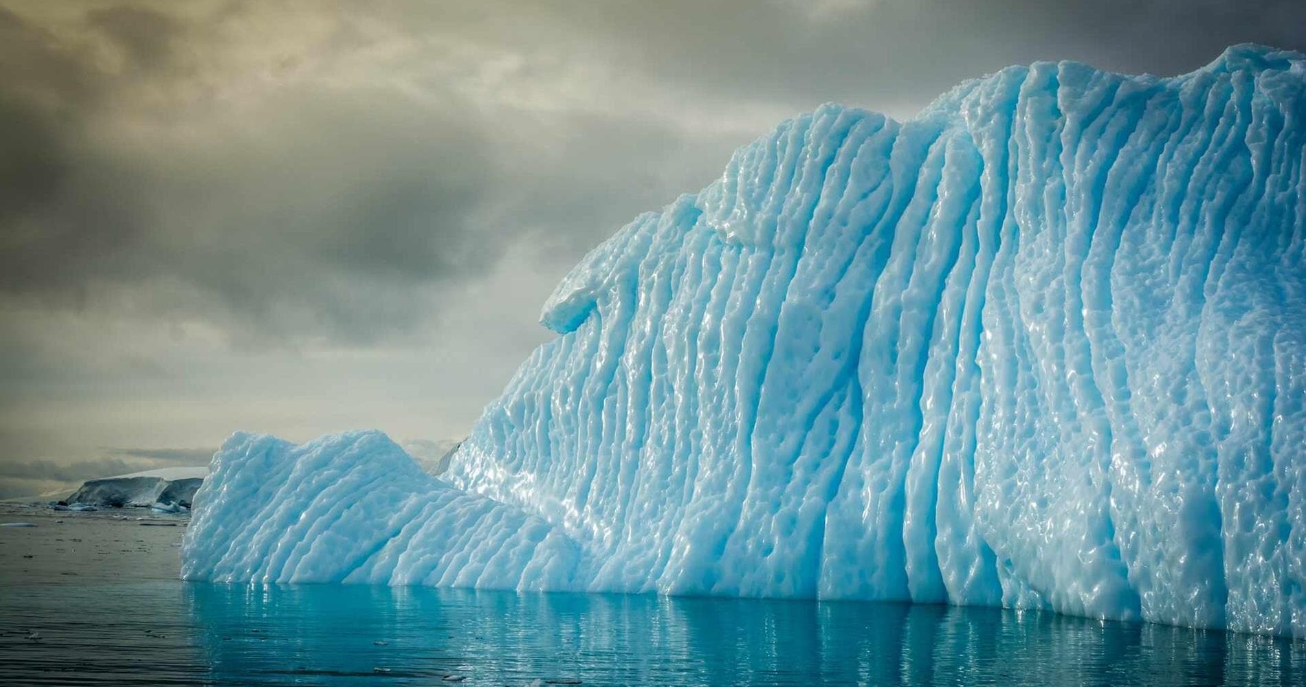 towering iceberg during a cloudy sky, Antarctica